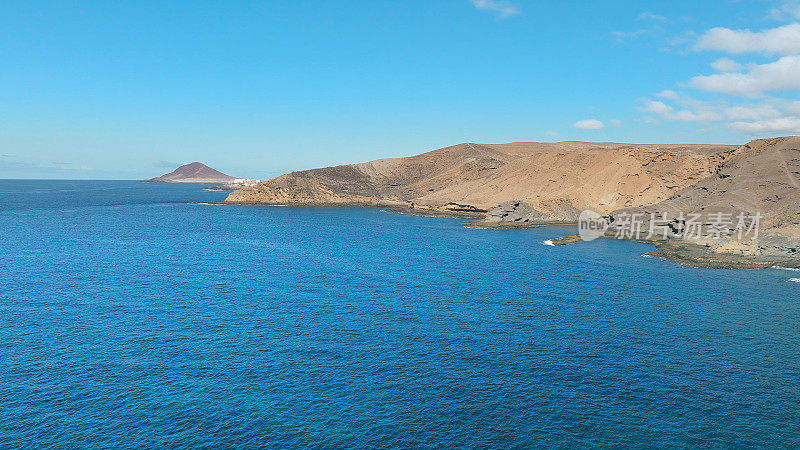 Aerial view of the beach "Playa Escondida" and the natural reserve of "Montaña Pelada" in Tenerife (Canary Islands). Drone shot